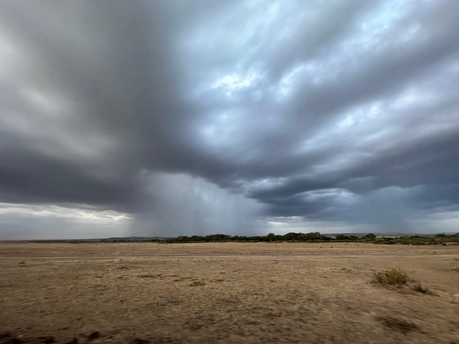 A rainstorm sweeps across the open plains of the Masai Mara, Narok County, Kenya (file photo, August 2023).