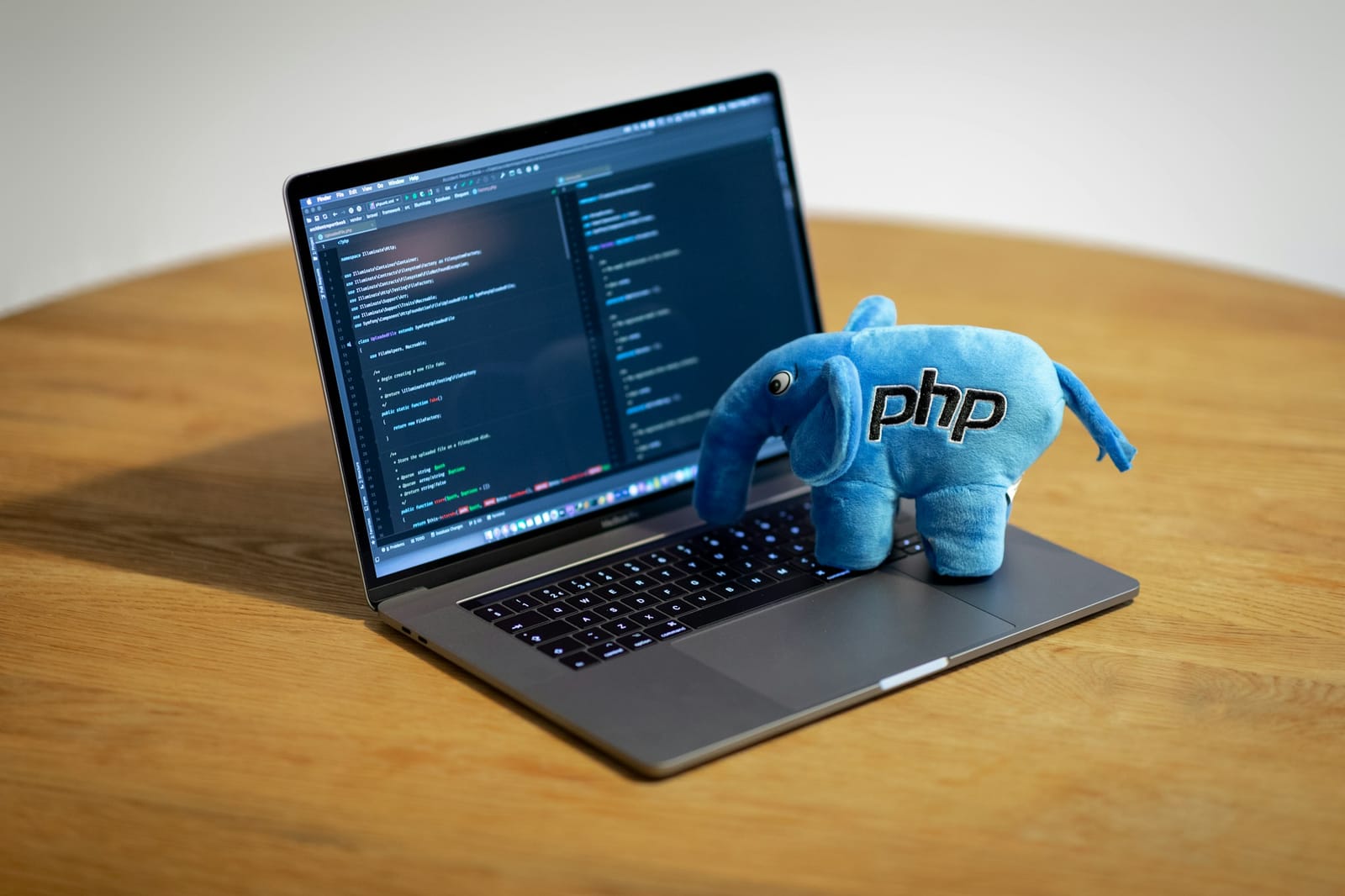 A plush toy of the PHP elephant mascot on a MacBook Pro laptop running the PhpStorm code editor (file photo).