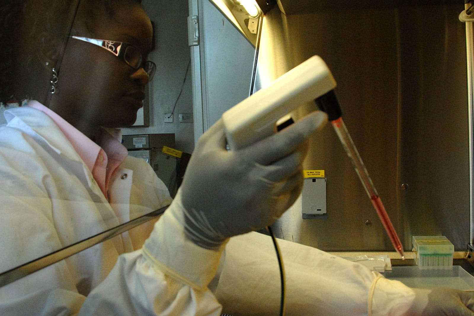 A laboratory technician works with a sample behind a biosafety hood at the Kenya Medical Research Institute in Nairobi (file photo; not from the TARGET trial).