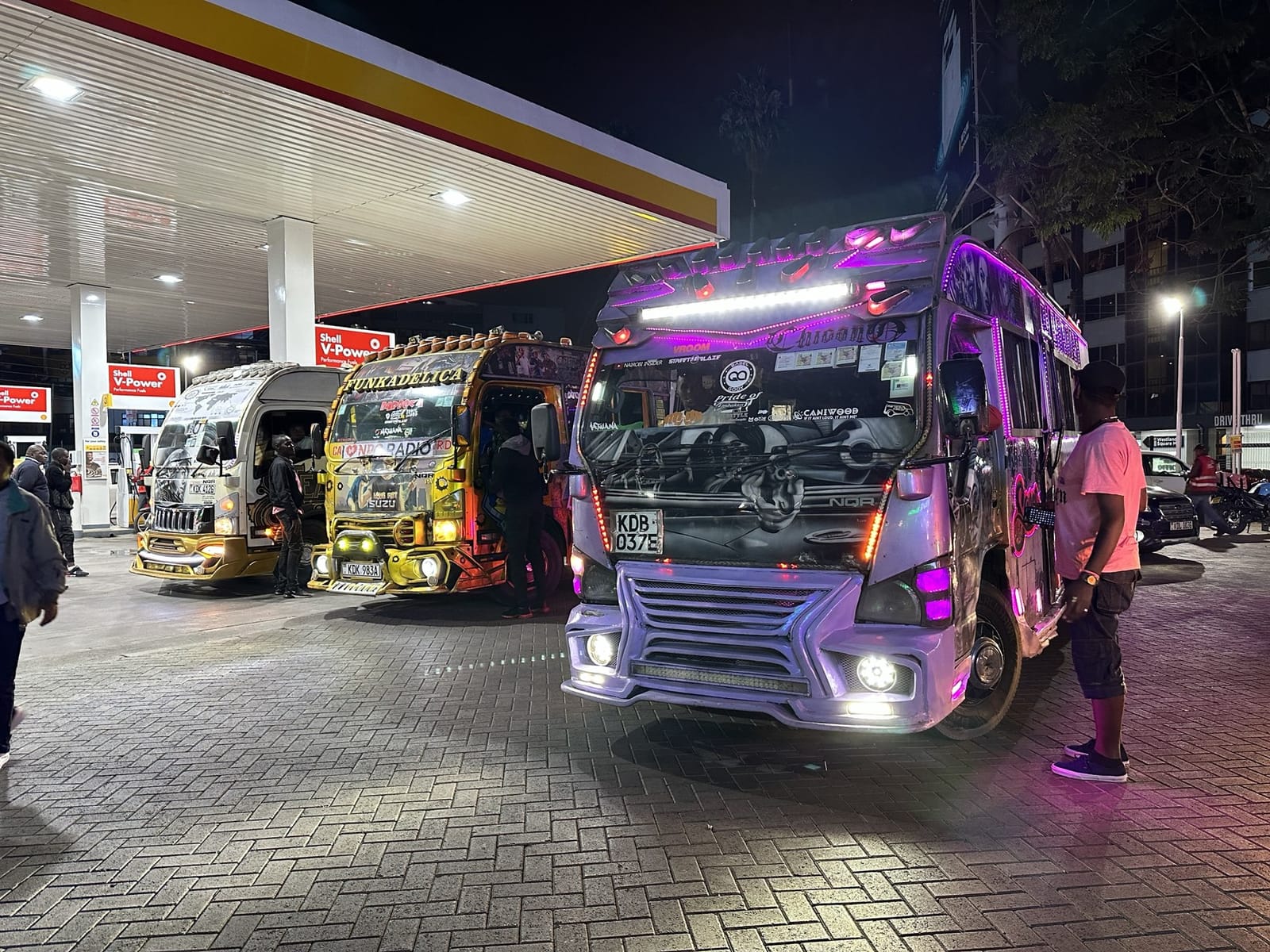 Matatu minibuses at a fuel station at night in Nairobi (file photo, 2023).