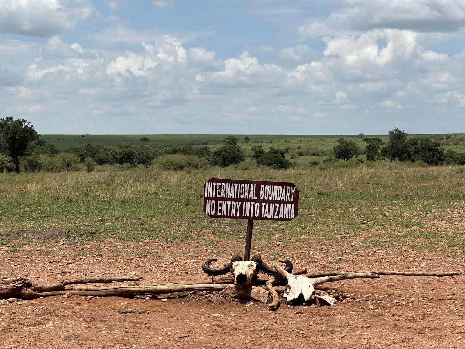 A sign on the Kenya–Tanzania border in the savanna near the Mara reads "International Boundary, No Entry into Tanzania" (file photo, 2023).