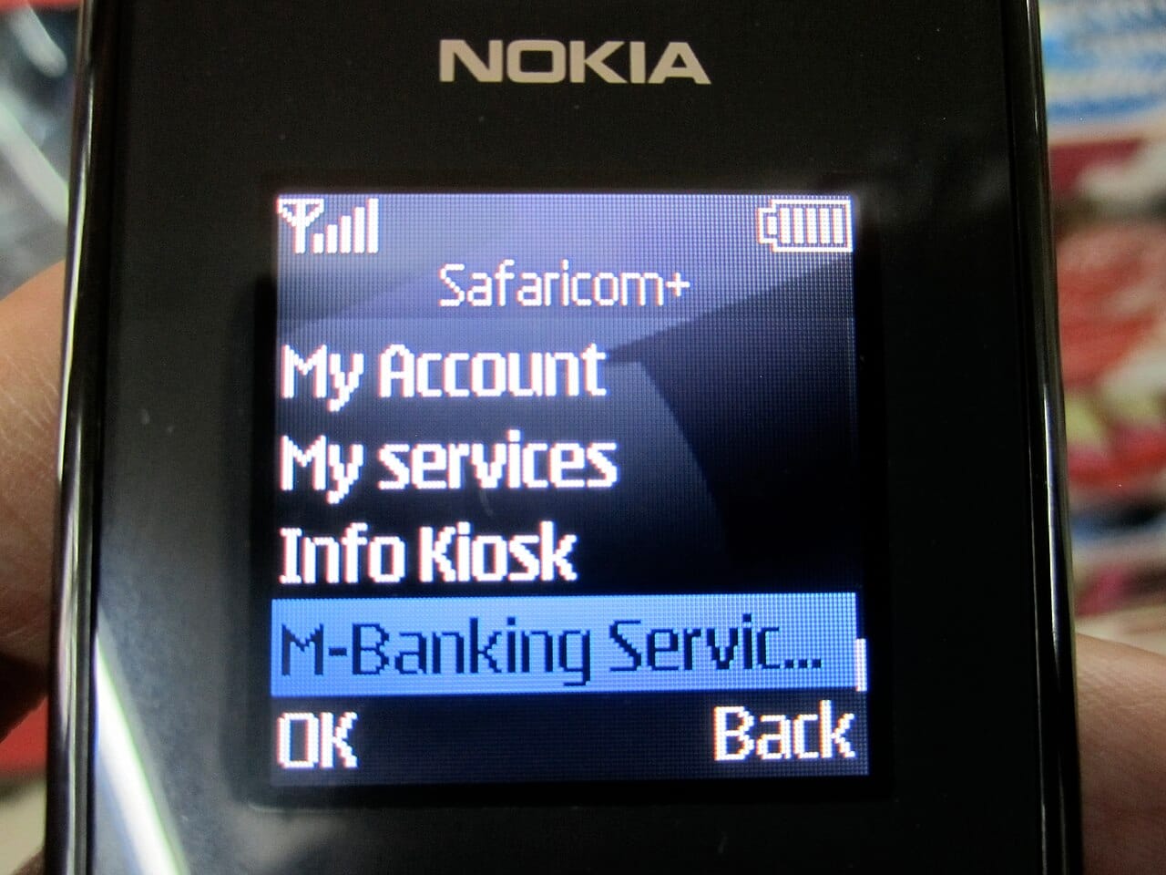 Illustrative file photo: a Nokia feature phone showing Safaricom's M-Pesa menu. Basic phones like this receive SMS alerts; the image is not from the emergency-alert test.